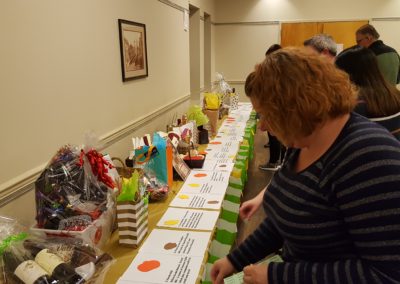 Guests viewing and bidding on the raffle baskets.